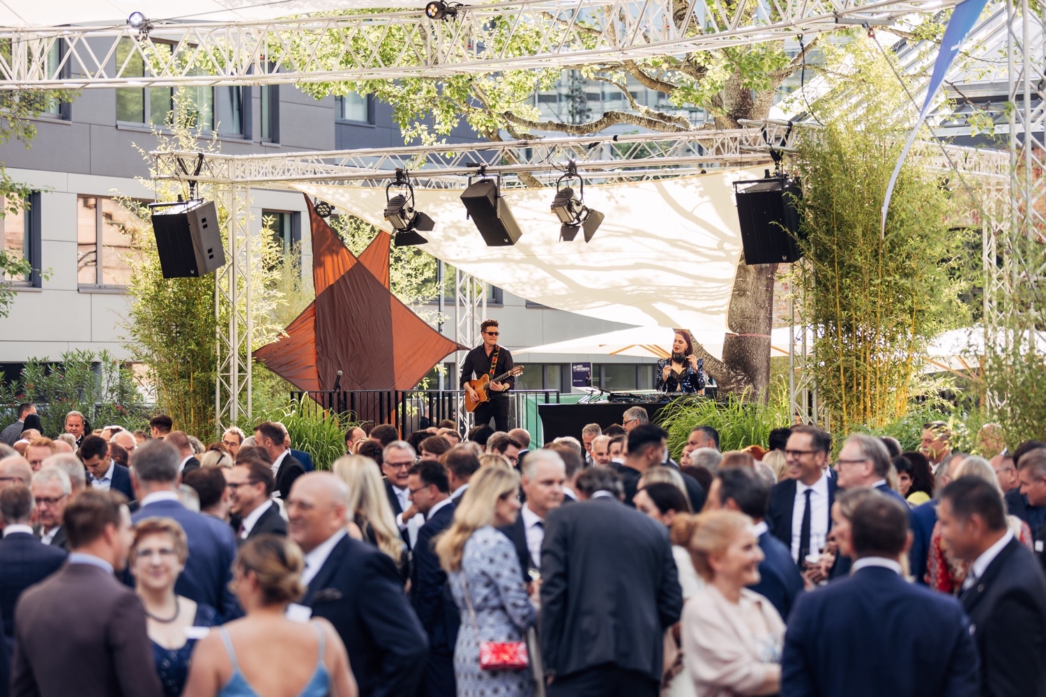 Live-Musik im Außenbereich der BANSBACH Jubiläumsveranstaltung Großer Außenbereich der 100 Jahre BANSBACH Gala mit Live-Bühne, Musikern und festlicher Abendstimmung