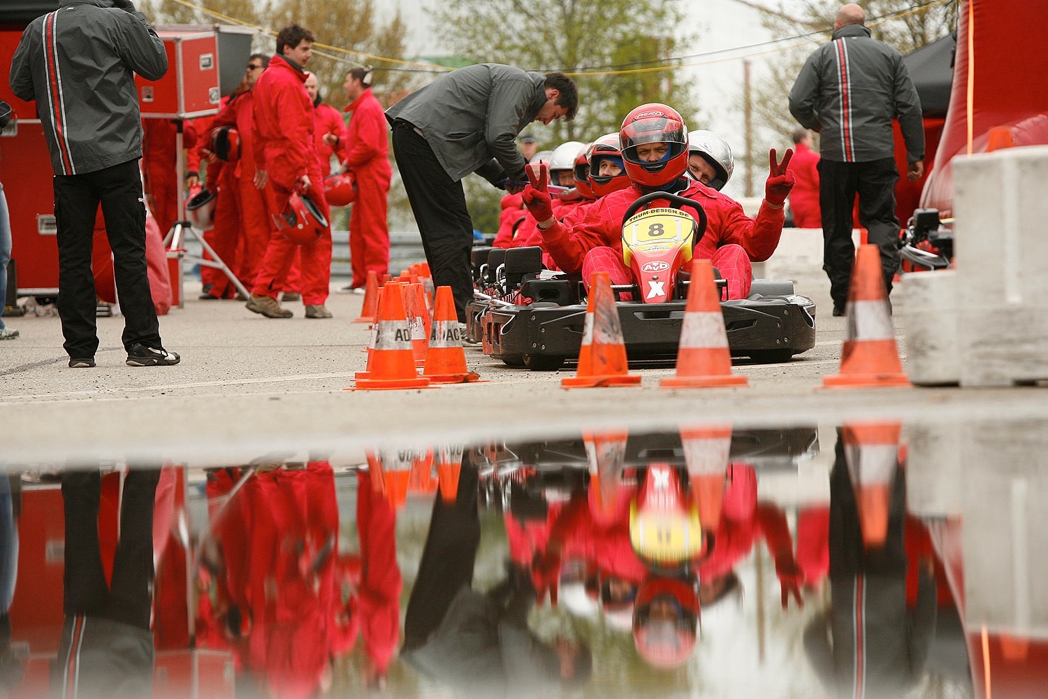 Participants carry out a pit stop on a go-kart at the EMC Power and Speed Event