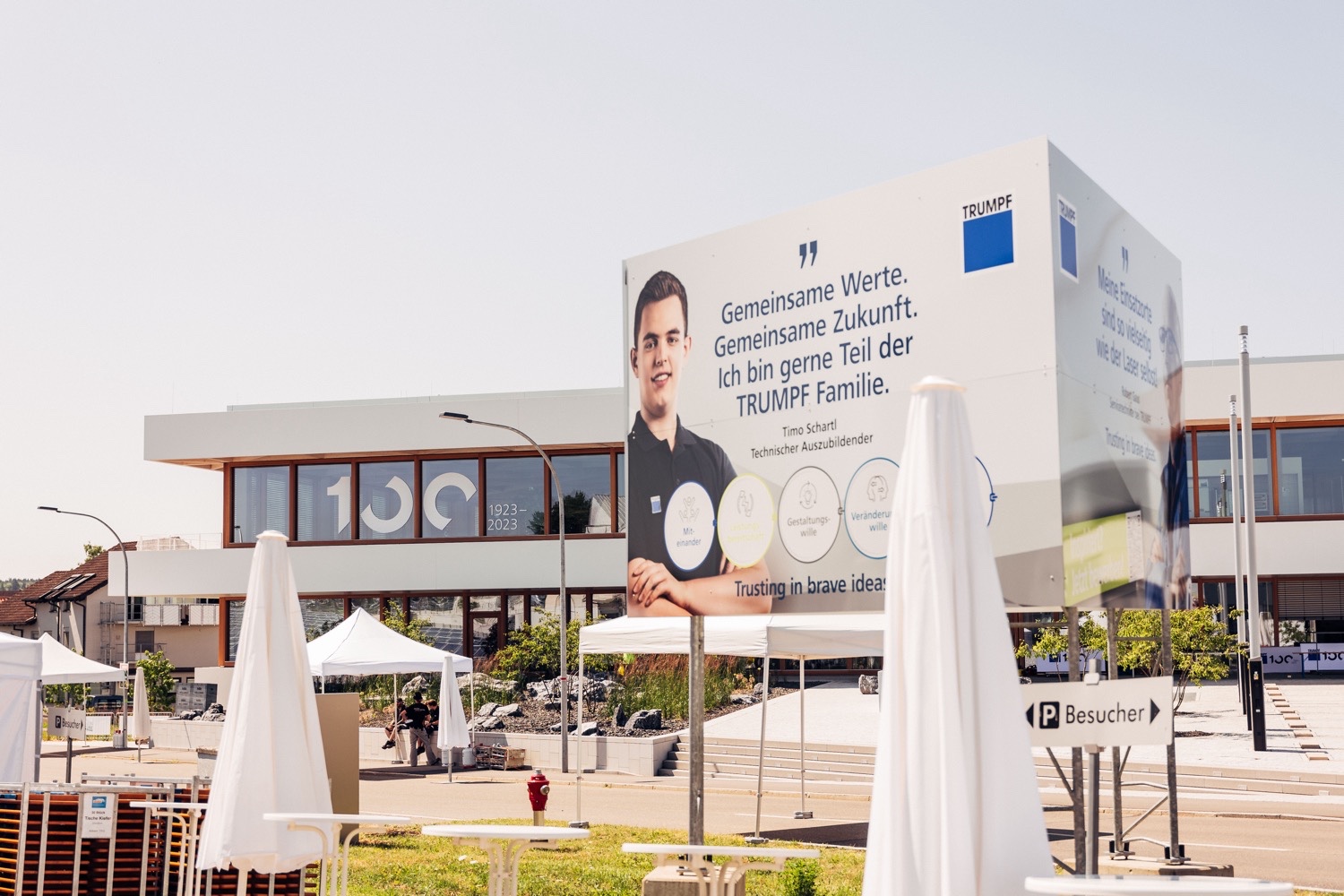Branded outdoor area featuring Mission Future displays Outdoor area of the TRUMPF 100 event featuring large, three-sided Mission Future displays