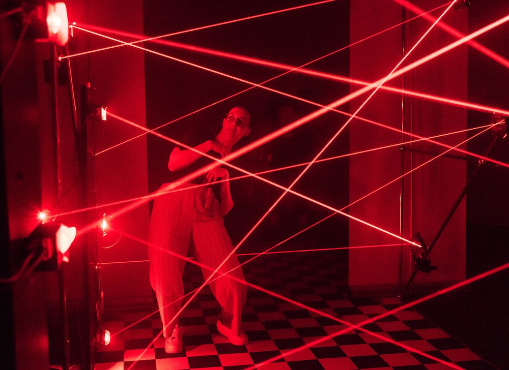Laser maze as a hands-on activity at the Mission Future event A participant crawls through a laser maze as part of an interactive experience station at the TRUMPF 100 event